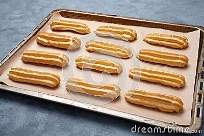 Traditional eclairs or profiterole dessert filled with whipped cream Stock Photo