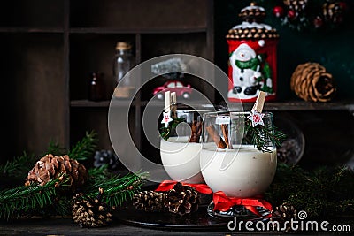 Traditional eggnog Christmas cocktail in a glass goblet decorated with New Year clothespin. Non-alcoholic option Stock Photo