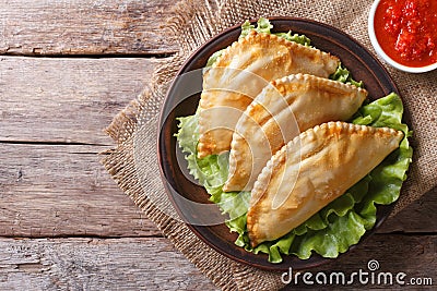 Traditional empanadas and sauce closeup. horizontal top view Stock Photo