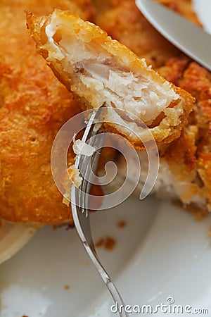 Traditional english dish with battered white cod, french fries and fresh vegetable served on a white plate Stock Photo