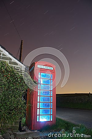 Traditional english phonebox at night Stock Photo