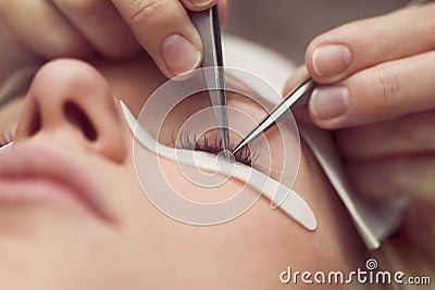 Traditional eyelash extensions. Selective focus. Toned. Makeup close-up. Stock Photo