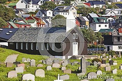 Traditional faroese village with church and cemetery. Sorvagur, Faroe Stock Photo