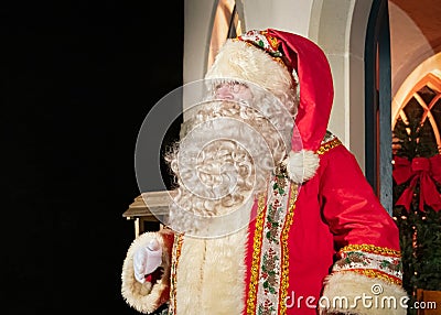 UK, Belfast - Dec 2012: Traditional Father Christmas character outside a brightly lit christmas house Editorial Stock Photo