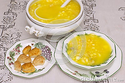 Traditional fish and shellfish soup with visible clams, saffron, shrimp, and other ingredients served in a porcelain tureen Stock Photo