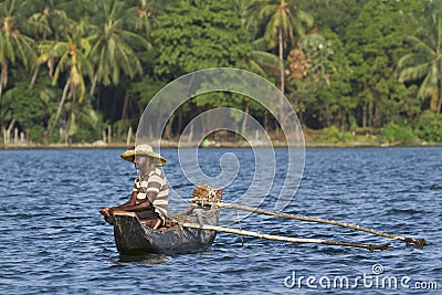 Traditional fisherman in dugout canoe in Sri Lanka Editorial Stock Photo