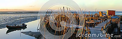 Traditional fishermen wooden jetties. Stilt piers or Cais Palafitico by the Sado River estuary Editorial Stock Photo