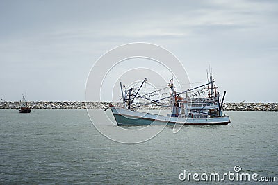 Traditional fishing boat laying on the sea.cloudy sky.filtered image.selective focus. Stock Photo