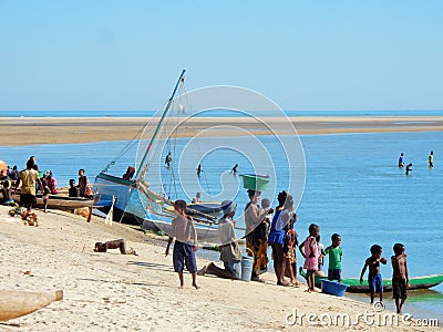 Traditional fishing boats on beach with locals, Madagascar Editorial Stock Photo