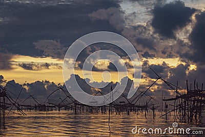 Traditional fishing nets over cloudy sunrise Stock Photo