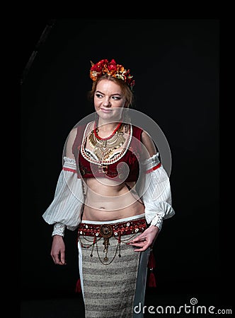Traditional folk slavic costume for belly dance and trible with circlet of flowers, vest, skirt, sleeves and necklace Stock Photo