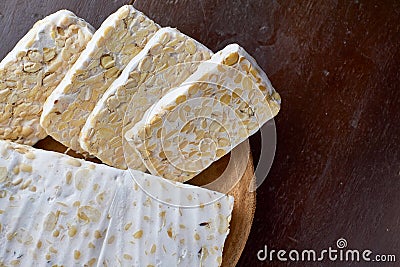 Traditional food of indonesia, Slice of tempeh on the wood background Stock Photo