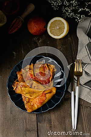 Traditional french crepes suzette with red bloody oranges, russian blini pancakes - Shrovetide maslenitsa festival meal Stock Photo