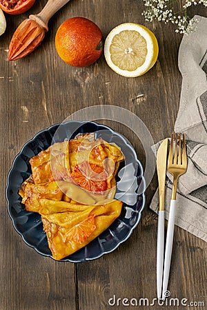 Traditional french crepes suzette with red bloody oranges, russian blini pancakes - Shrovetide maslenitsa festival meal Stock Photo
