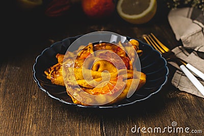 Traditional french crepes suzette with red bloody oranges, russian blini pancakes - Shrovetide maslenitsa festival meal Stock Photo