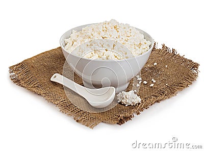 Traditional fresh cottage cheese on vintage burlap close-up on a white background. Stock Photo