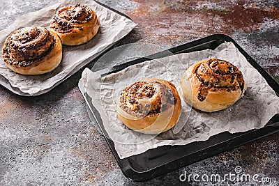 Traditional fresh sweet homemade cinnamon rolls with chocolate cream on a baking sheet. Scandinavian cuisine. Hyugge style Stock Photo