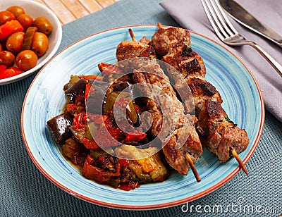 Grilled pork meat shashlik with sauteed vegetables Stock Photo