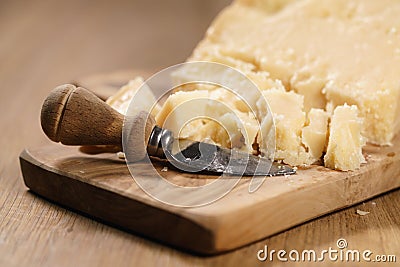 Traditional grana padano italian cheese on olive board Stock Photo