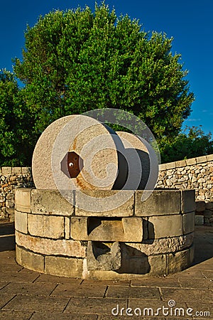 Traditional granite mill for pressing olives. Typical Salento farmhouse, Puglia Italy. Stock Photo