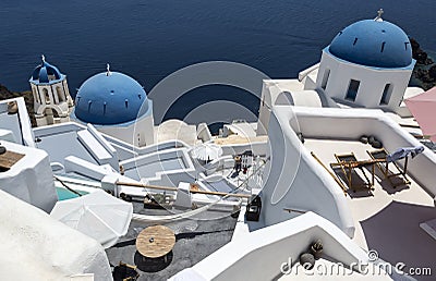 Traditional Greek white church arch with cross and bells in village Oia of Cyclades Island Santorini Greece Stock Photo