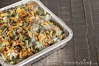 Traditional Green Bean Casserole with Fried Onions on a Wooden Table Stock Photo