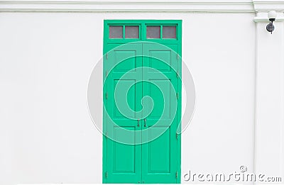 traditional green door wooden of an old on white wall Stock Photo