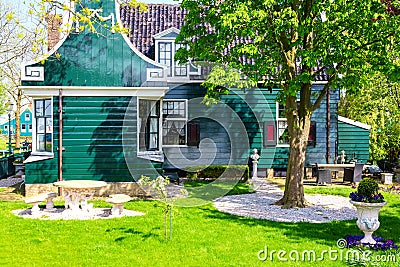 Traditional green dutch house in the Zaanse Schans village with green meadow. Typical Netherlands image. Famous tourist attraction Stock Photo