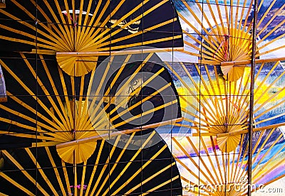 Traditional hand fans umbrellas in a row on wall - Chiang Mai, Thailand Stock Photo
