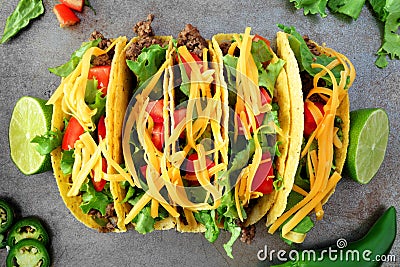 Traditional hard shelled tacos, overhead view on rustic tray Stock Photo