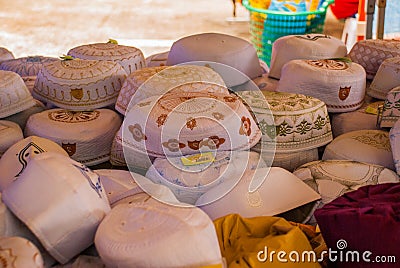 The traditional headgear of the Muslims men in the market. Malaysia Editorial Stock Photo