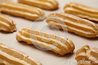 Traditional homemade eclairs or profiterole dessert on baking sheet Stock Photo