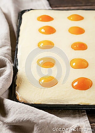 Traditional homemade `Fried eggs` apricot cake on a baking plate. Stock Photo