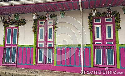 Traditional house facade with colorful painted doors and wooden panelling, Salento. Columbia Stock Photo