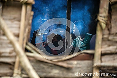 Traditional house Korowai people tribe. View inside the house through the window Editorial Stock Photo