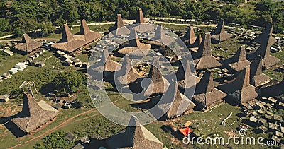 Traditional houses village with unique roofs at green valley with tropic tree. Epic tourist landmark Stock Photo