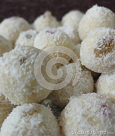 Traditional Indian dessert coconut balls / nariyal ladoos filled with lots of raisins Stock Photo