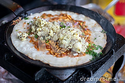 Traditional indian dosa with potato cooking on skillet Stock Photo
