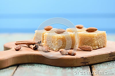 Traditional Indian sweetmeats, semolina halava with almonds on w Stock Photo