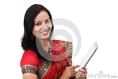 Traditional Indian woman holding a laptop computer Stock Photo