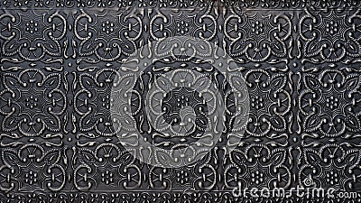 Traditional islamic rhythmic arabesque pattern in form of embossing on metal. Textured black silver carved metal backdrop Stock Photo