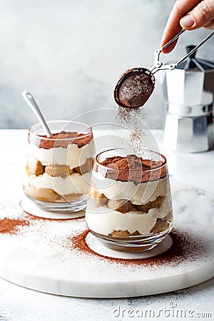 Traditional Italian dessert tiramisu in a glass. Stock Photo