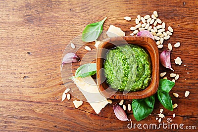 Traditional italian fresh pesto sauce with raw ingredients top view. Healthy and organic food. Stock Photo