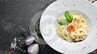 Traditional Italian pasta dish, spaghetti carbonara with yolk, parmesan cheese on a plate. Stock Photo