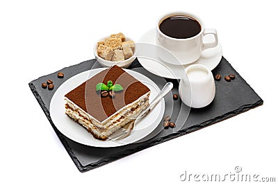 Traditional Italian Tiramisu dessert square portion on ceramic plate and cup of fresh espresso coffee on stone serving Stock Photo