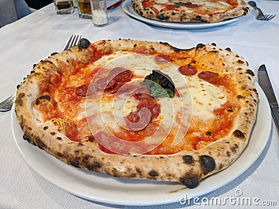 Traditional Italian wood fired oven baked pepperoni pizza Stock Photo