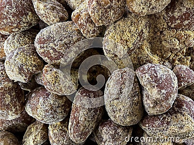 Traditional Jaggery Blocks (aka Gud, Gur, Sarkara) is a traditional non-centrifugal cane sugar at fresh food market. Stock Photo