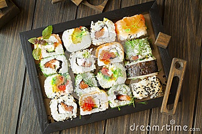 Traditional japanese food on a dark wooden background. Sushi rolls. Asian food frame. Dinner party. Top view image Stock Photo