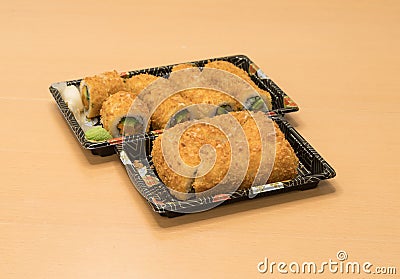 Traditional Japanese food - portion of several kinds of sushi, with sushi toast, cut into four pieces on a trays with wasabi and p Stock Photo