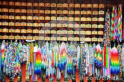 Traditional Japanese Thousand origami cranes and O-mikuji Editorial Stock Photo